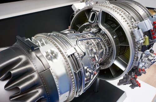 A cutaway jet engine mounted on a test stand